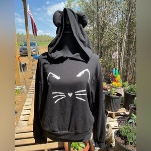 No name sweatshirt with a cat face. Size M. Black. Hood with ears.
